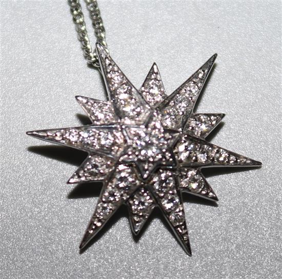 An 18ct white gold and diamond starburst pendant, on an 18ct white gold chain, pendant 1in.